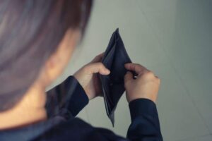woman open wallet with no money inside